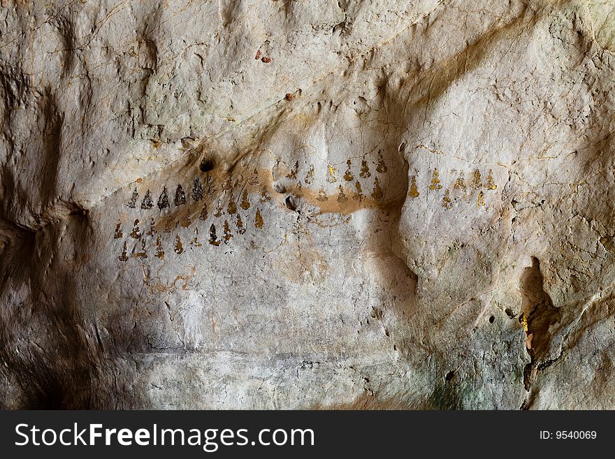 Budhist symbols on a cave wall