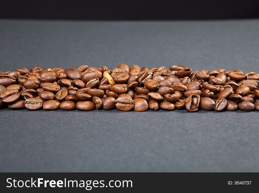 Strip from coffee beans against a dark background