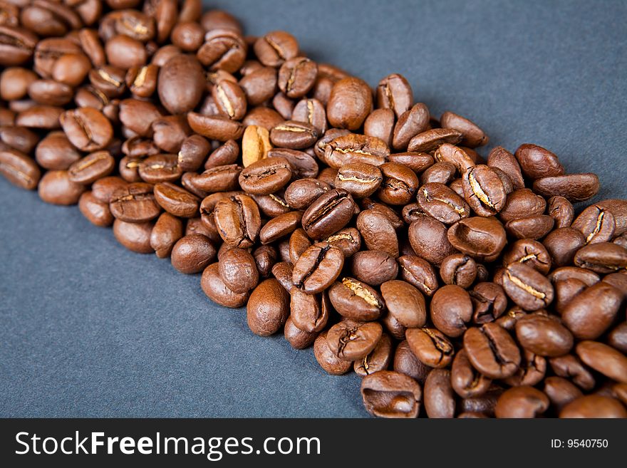 Strip from coffee beans against a dark background. Strip from coffee beans against a dark background