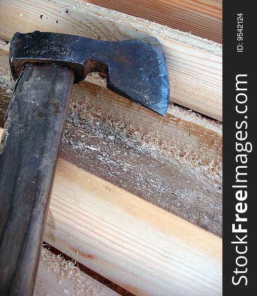 An axe and the wood in front of the cottage. An axe and the wood in front of the cottage