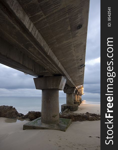 A photograph of a pier in Port Elizabeth, South Africa before sunrise. A photograph of a pier in Port Elizabeth, South Africa before sunrise.