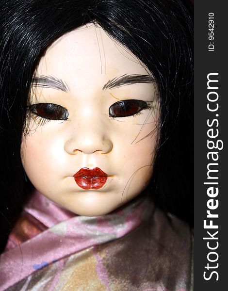 A closeup of the face of asian doll. A closeup of the face of asian doll