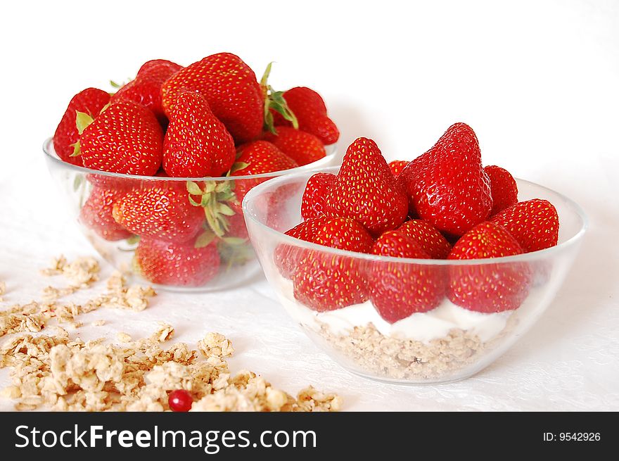 Strawberries, youghurt and muessli on a white table. Strawberries, youghurt and muessli on a white table