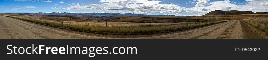 A panaroma of the tail of the Drakensberg mountain range on a dusty farm road this is in the Eastern Cape in South Africa. A panaroma of the tail of the Drakensberg mountain range on a dusty farm road this is in the Eastern Cape in South Africa