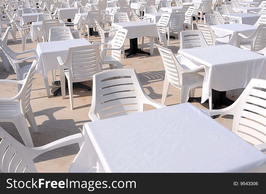 White chairs and tables on a teracce