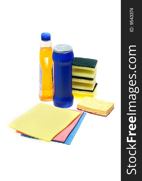 Cleaning supplies on white background including several spray bottles of chemicals,  sponges