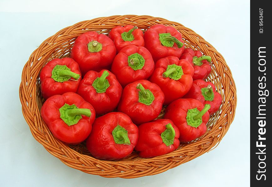 A background of red hot capsicums arranged properly in a wooden basket. A background of red hot capsicums arranged properly in a wooden basket