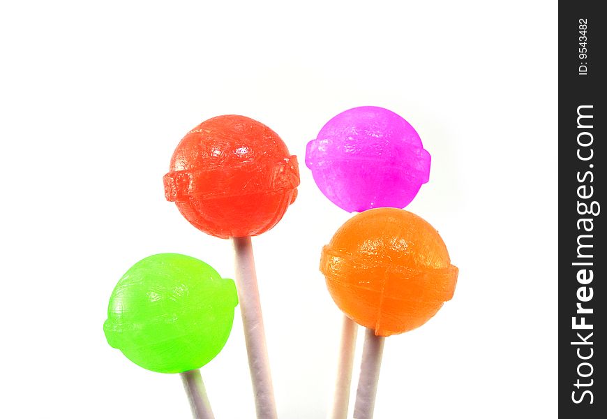 Four colorful lollipops against a white background.