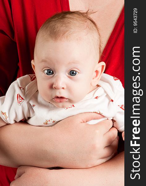 Beauty baby boy with blue eyes on claret red background.