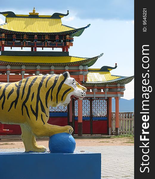 A statue of tiger with ball in buddhist university monastery. A statue of tiger with ball in buddhist university monastery.