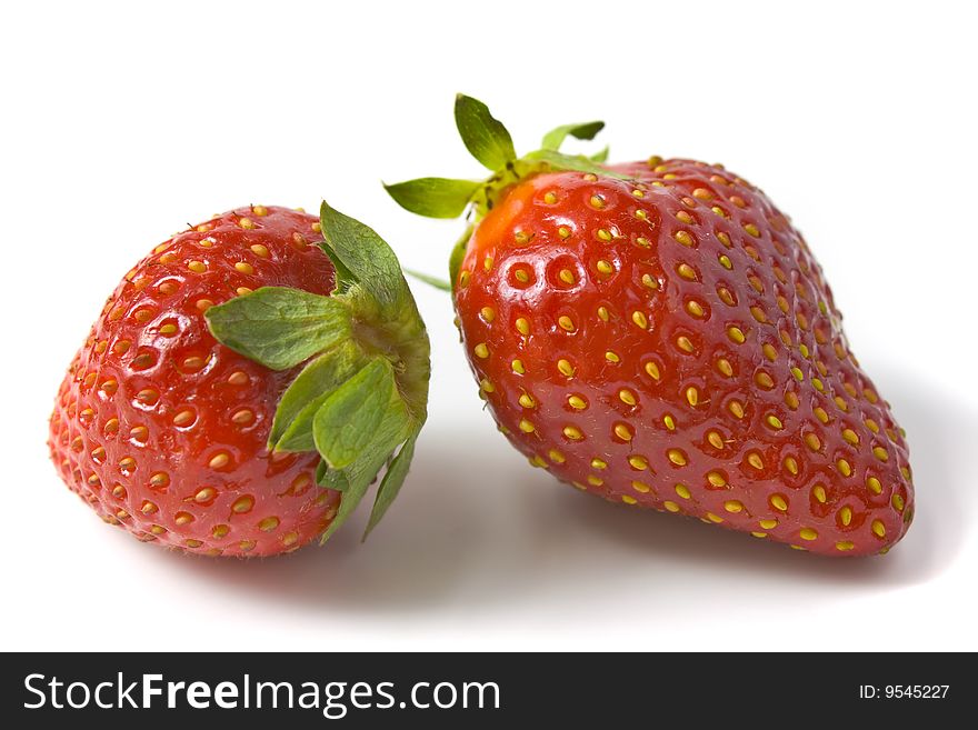 Two ripe and appetizing strawberries. A photo close up.