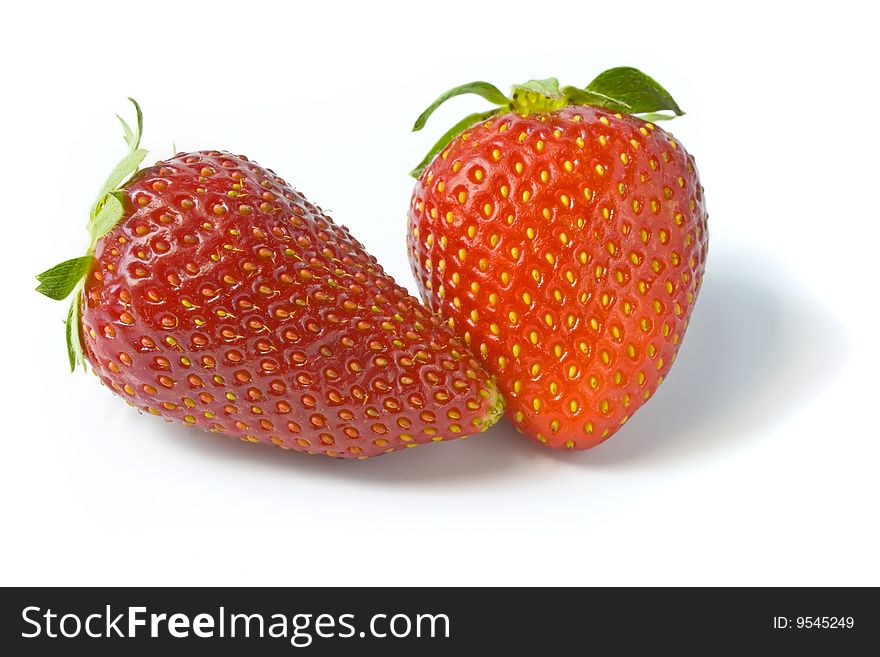 Two ripe and appetizing strawberries. A photo close up.