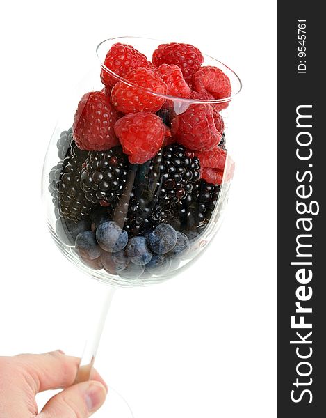 Juicy and fresh blueberries, blackberry and raspberry in wineglass