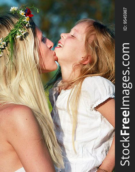 Mother and daughter outdoors portrait