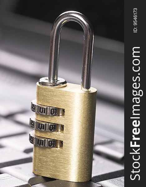 CLose up of a padlock on a laptop keyboard. CLose up of a padlock on a laptop keyboard