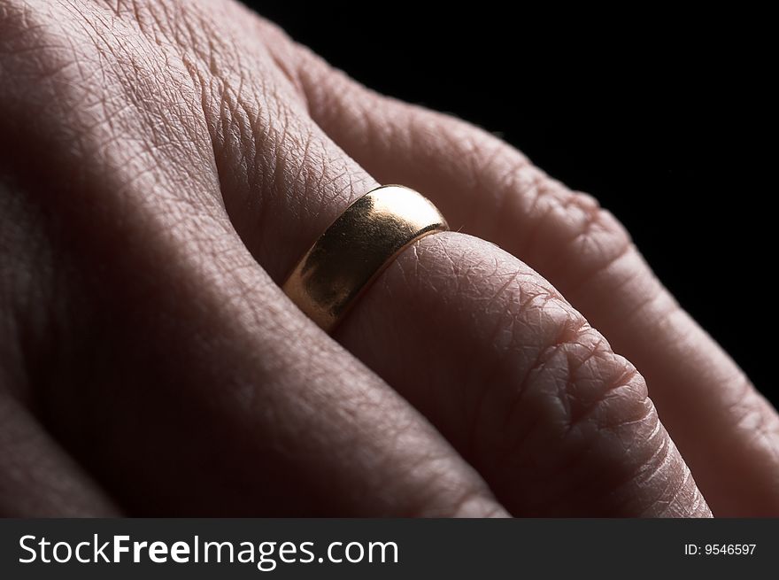 Backlit image of a wedding ring on an older womans hand. Backlit image of a wedding ring on an older womans hand.
