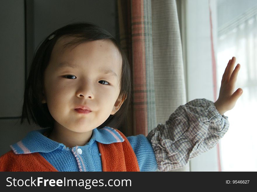 A Chinese girl playing by the window.