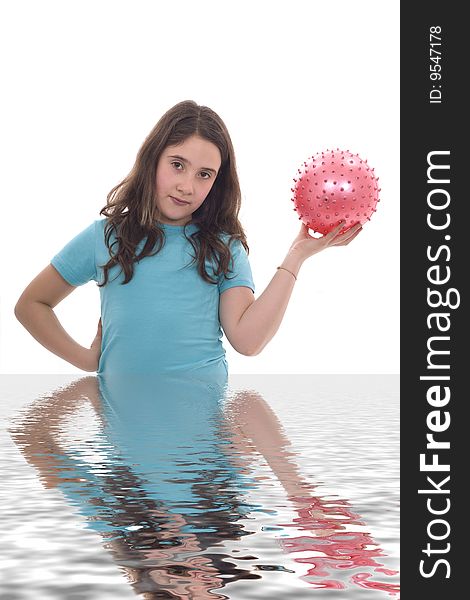 A young girl holding a pink ball and her own reflection. A young girl holding a pink ball and her own reflection