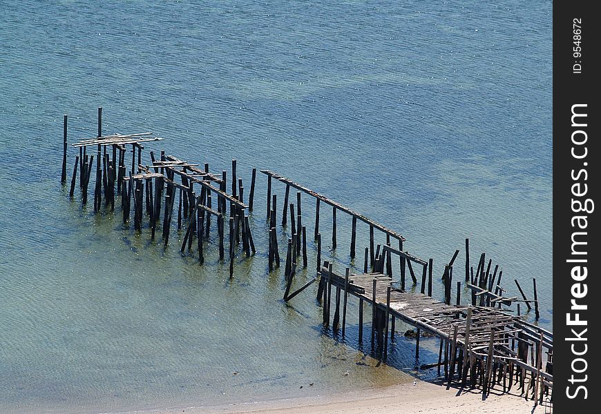 Collapsing Pier on shallow waters taken in Provincetown, MA on Cape Cod. Collapsing Pier on shallow waters taken in Provincetown, MA on Cape Cod