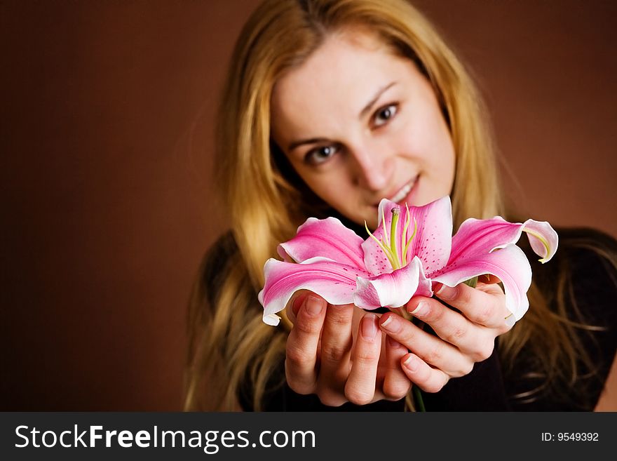 Young blonde with a pink lily