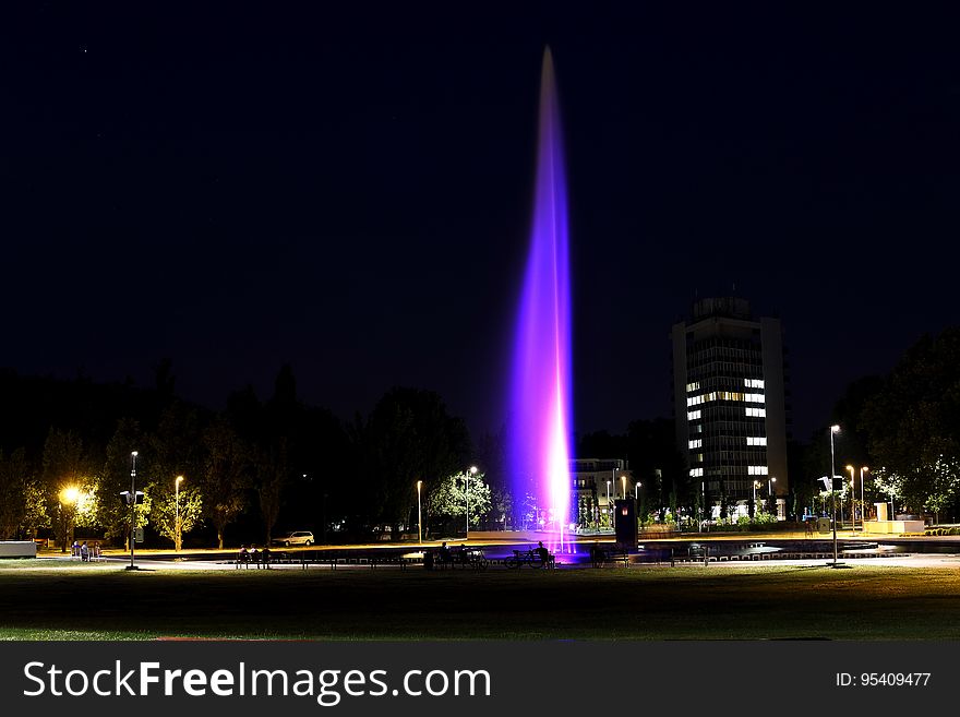 Illuminated Fountain In City Night Scene