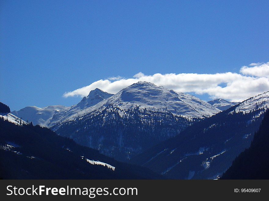 A view of mountain peaks covered in snow.