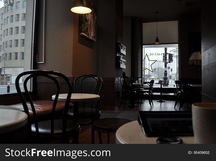 Interior of empty restaurant or cafe with tables and chairs. Interior of empty restaurant or cafe with tables and chairs.