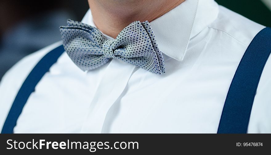 Man In White Dress Shirt Blue Suspenders And Gray Polka Dotted Bowtie