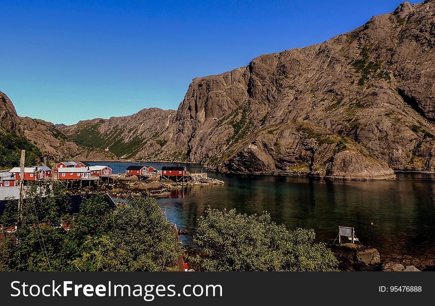 Red buildings in Scandinavian town on fjord waterfront on sunny day. Red buildings in Scandinavian town on fjord waterfront on sunny day.