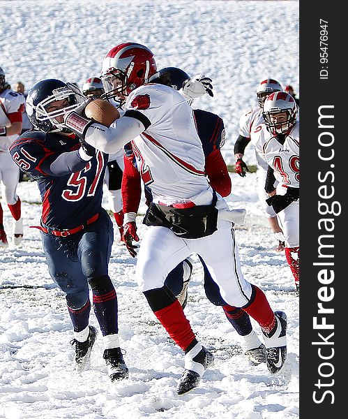 Football Players On Snowy Field