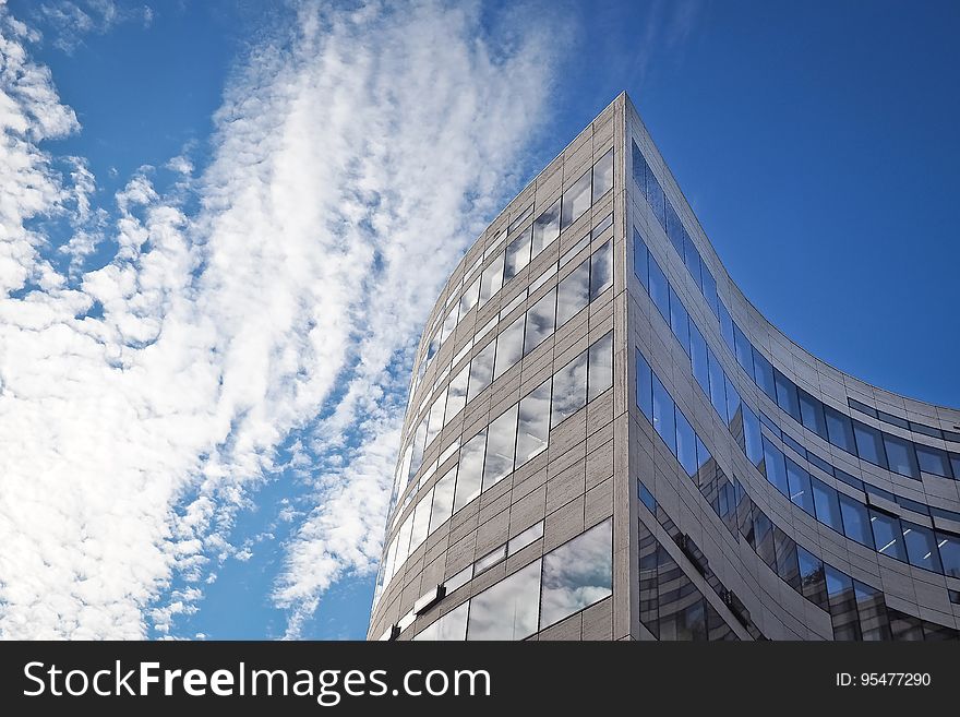 A modern office building and the sky in the background.
