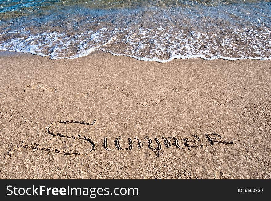 Inscription on sea sand near the sea