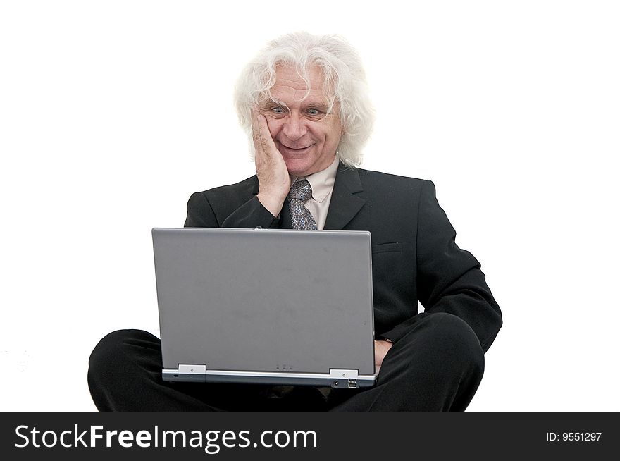Older business man smiling and typing on laptop. Older business man smiling and typing on laptop