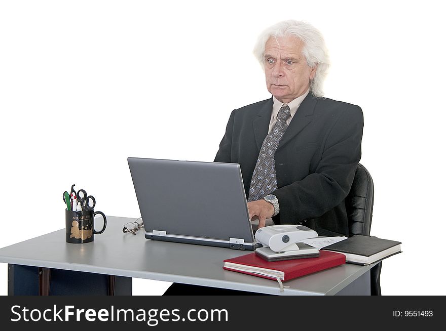 Older man worried typing on laptop
