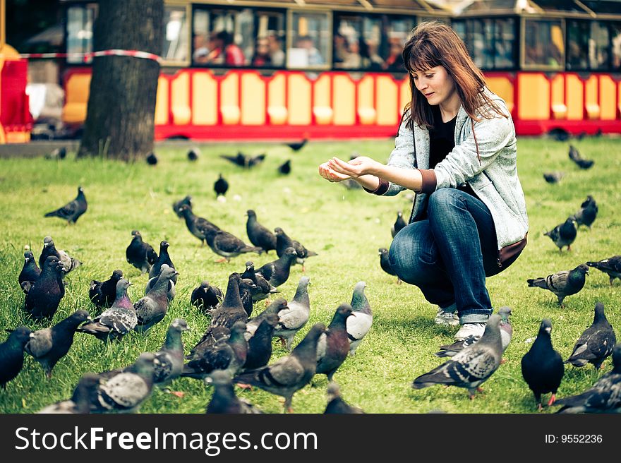Happy woman with doves in the park
