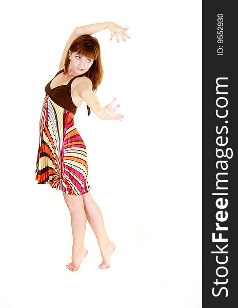 Dancing girl in colorful dress over white