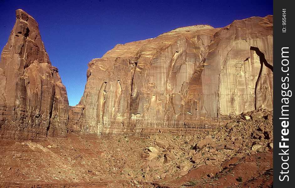 Landscape of Monument Valley Park. Front lit rocks, blue sky,. Landscape of Monument Valley Park. Front lit rocks, blue sky,