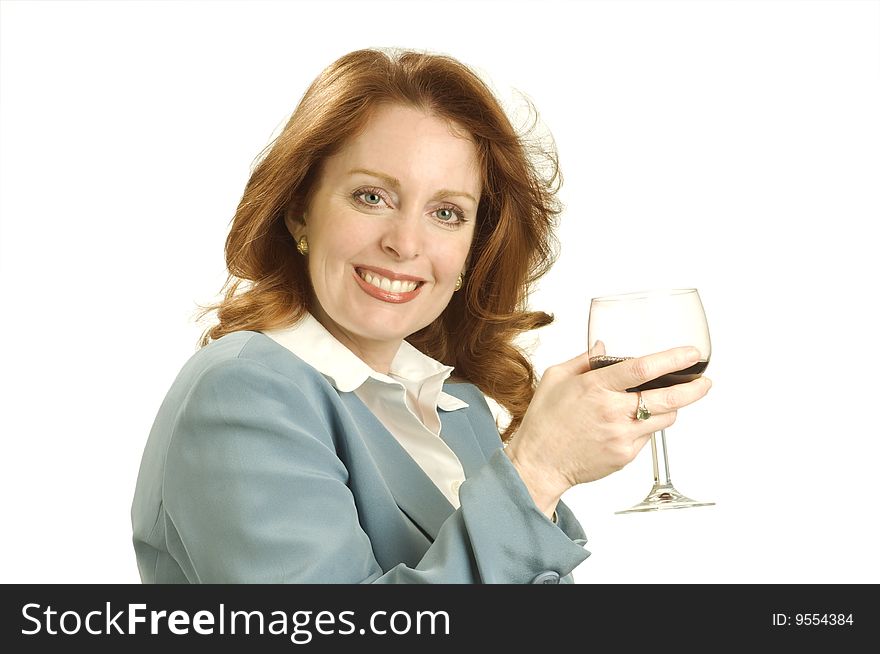 A woman in relaxes with a glass of wine against a light background. A woman in relaxes with a glass of wine against a light background