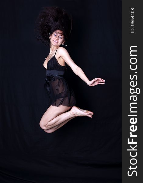 Dancer in jump against black