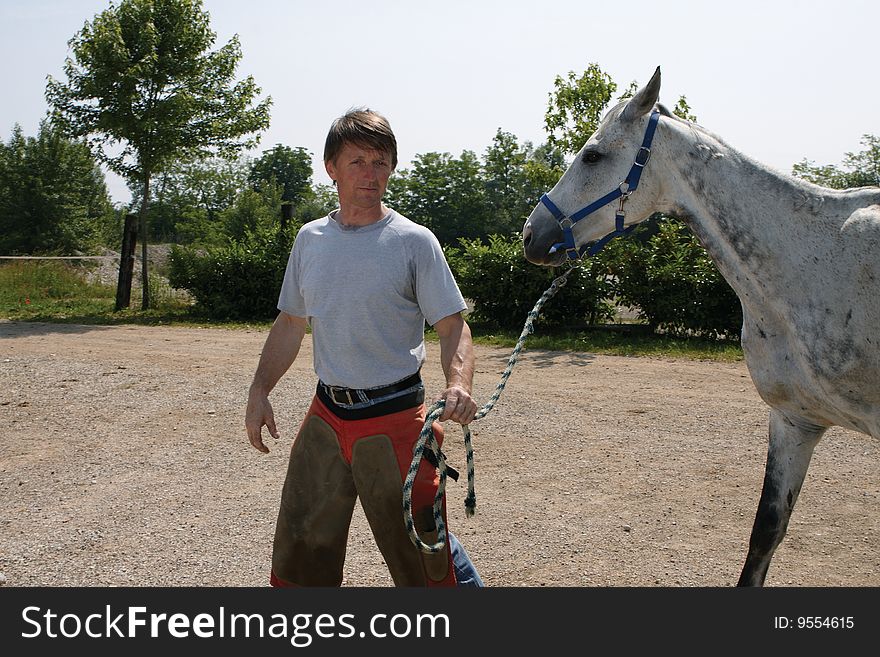 Farrier And Gray Horse
