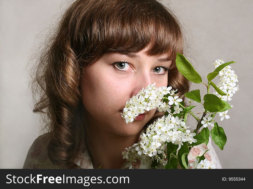 Girl with branch of bird cherry