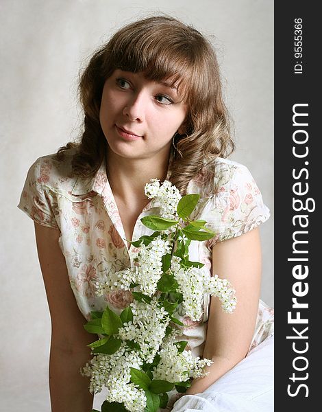 Portrait girl with branch of bird cherry