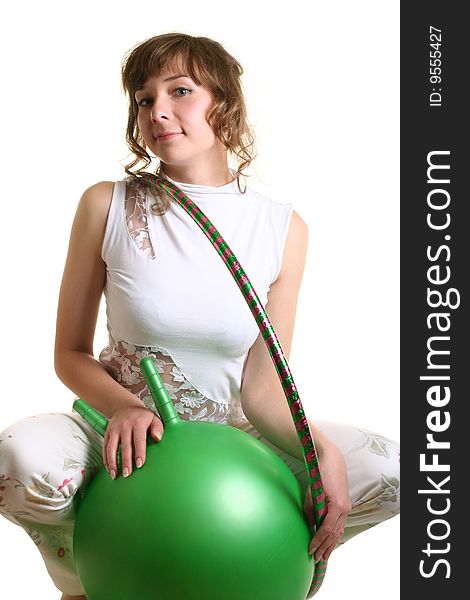 Sporty girl with big green ball and hoop