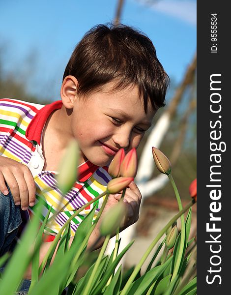 Little boy with tulips outdoors