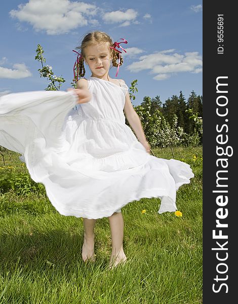 Little girl with white dress dancing