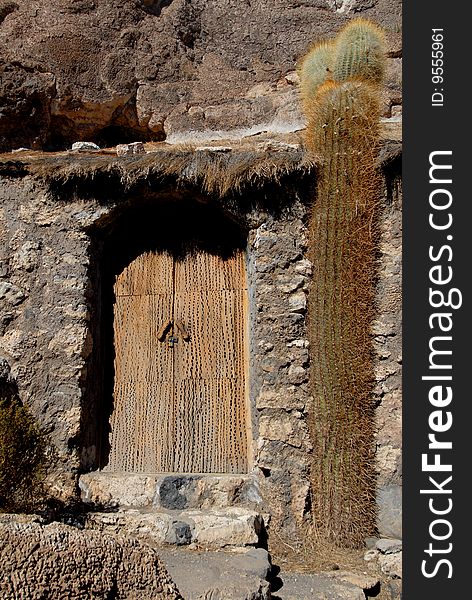 Bolivia, door of a house built in the rock