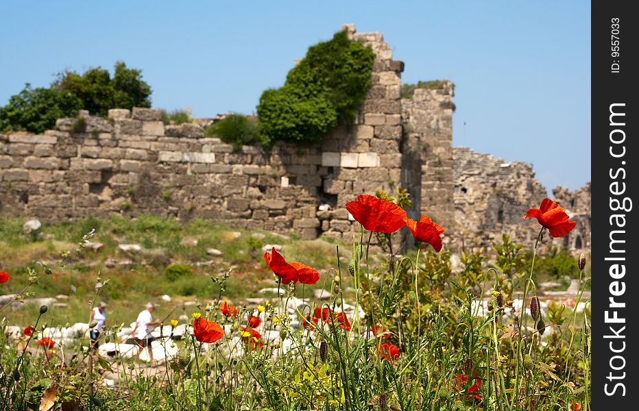 Ruins of old town. red poppies in the foreground