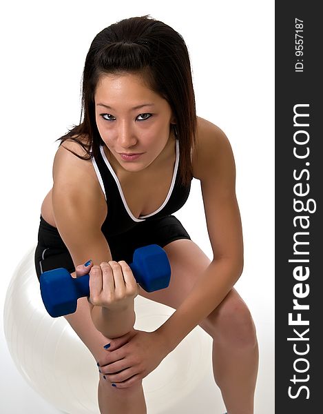 Fit, young, Asian woman exercising with weights. Fit, young, Asian woman exercising with weights.