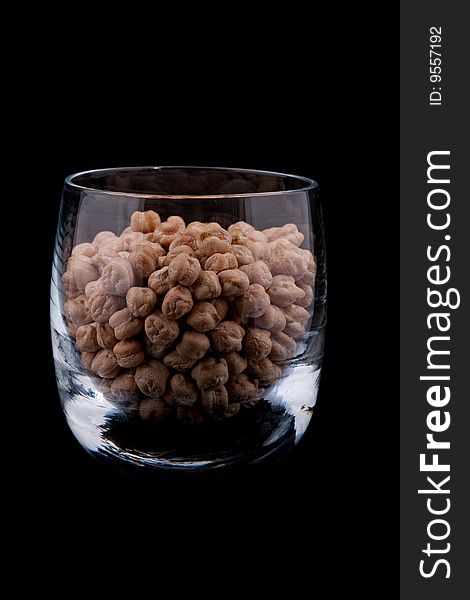 Chickpeas in glass, isolated on black background. Chickpeas in glass, isolated on black background