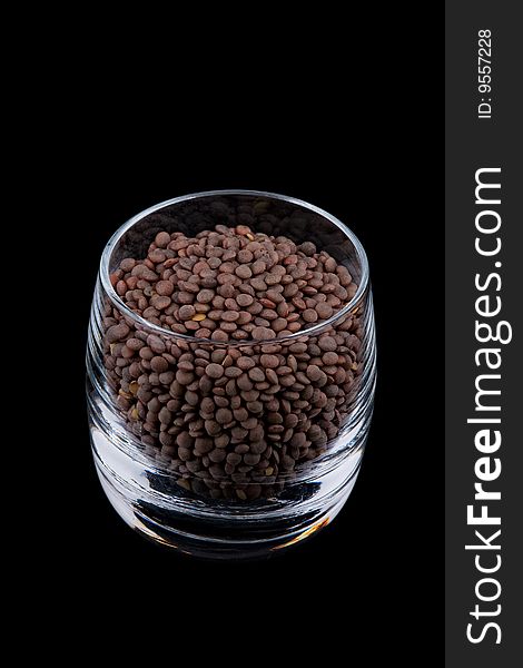 Pardina lentils in glass, isolated on black background. Pardina lentils in glass, isolated on black background